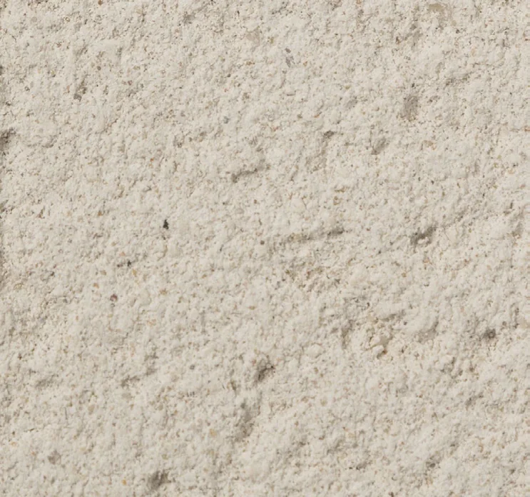Close-up sample of natural limestone with a warm, grainy surface.